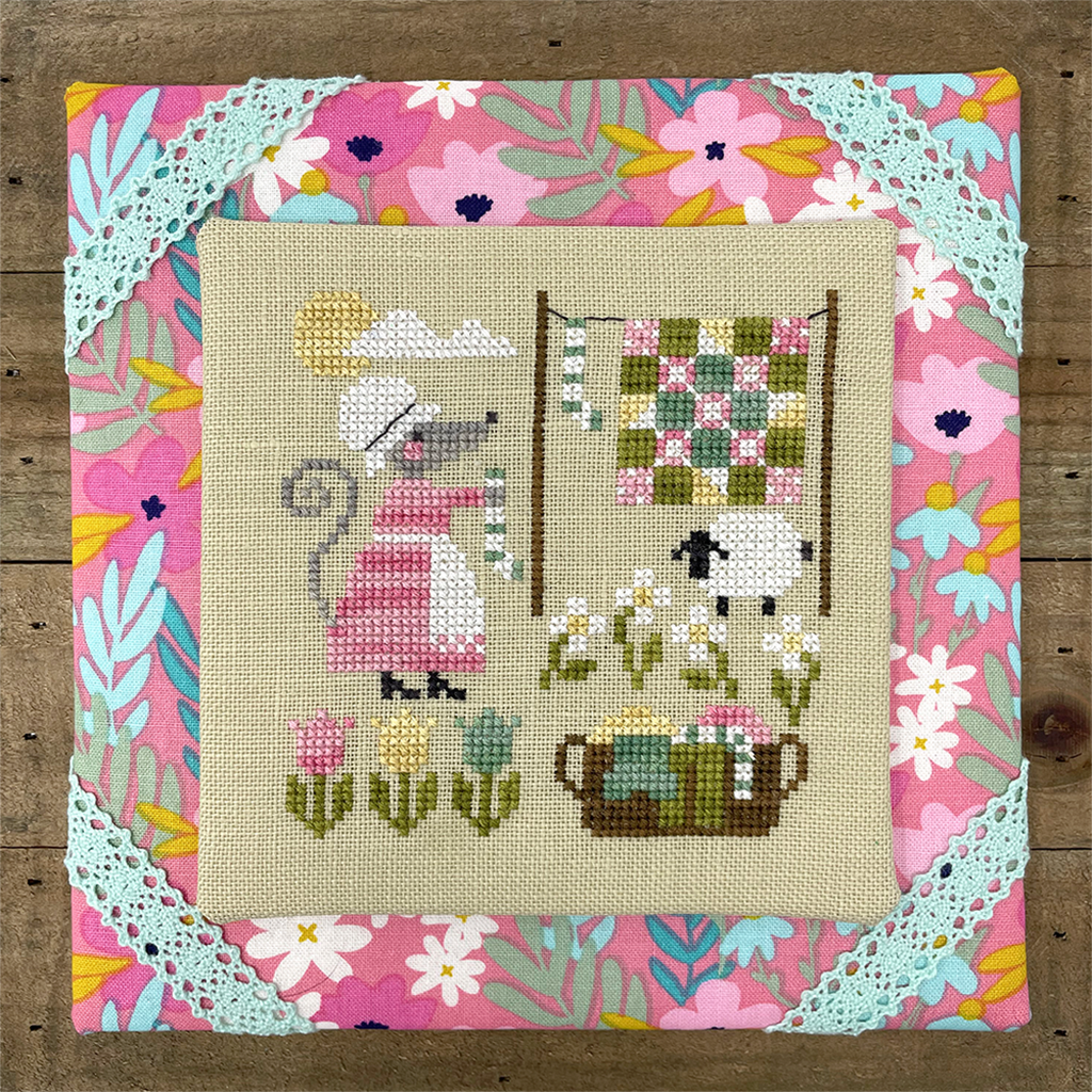 mouse in dress hanging laundry in spring