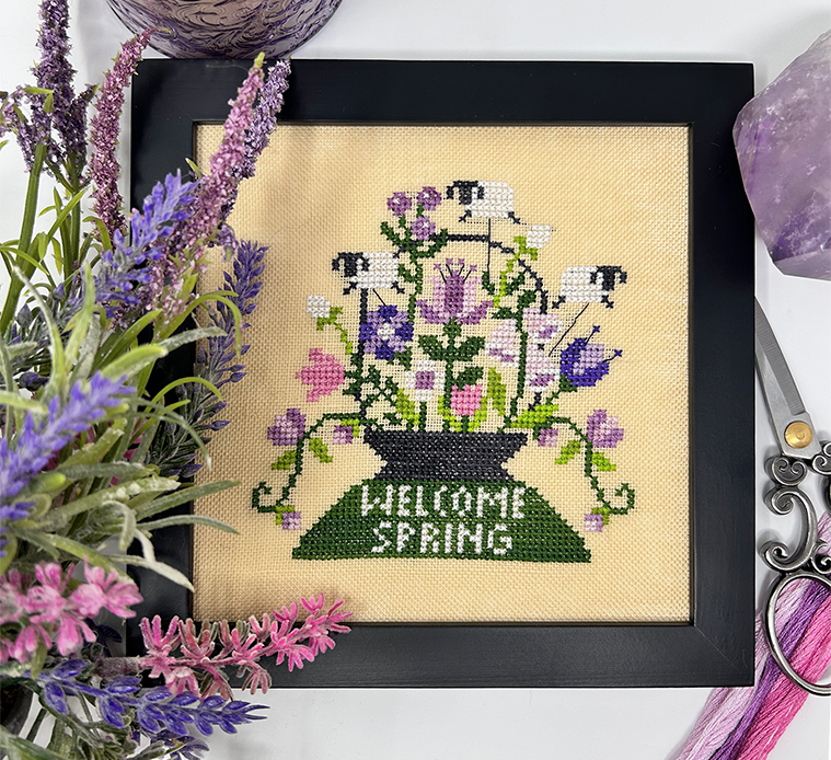 Sheep in flowers with the words welcome spring