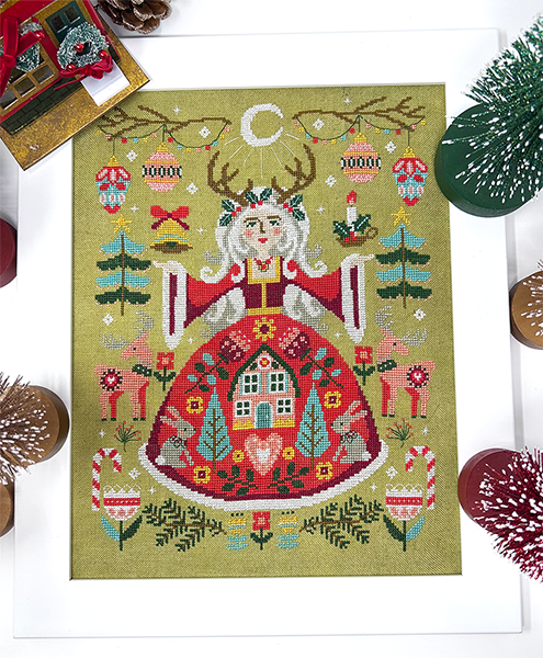 A colorful PDF cover for 'The Yule Goddess' cross stitch chart, depicting a stylized Yule Goddess figure surrounded by winter motifs like trees, animals, and decorative elements.