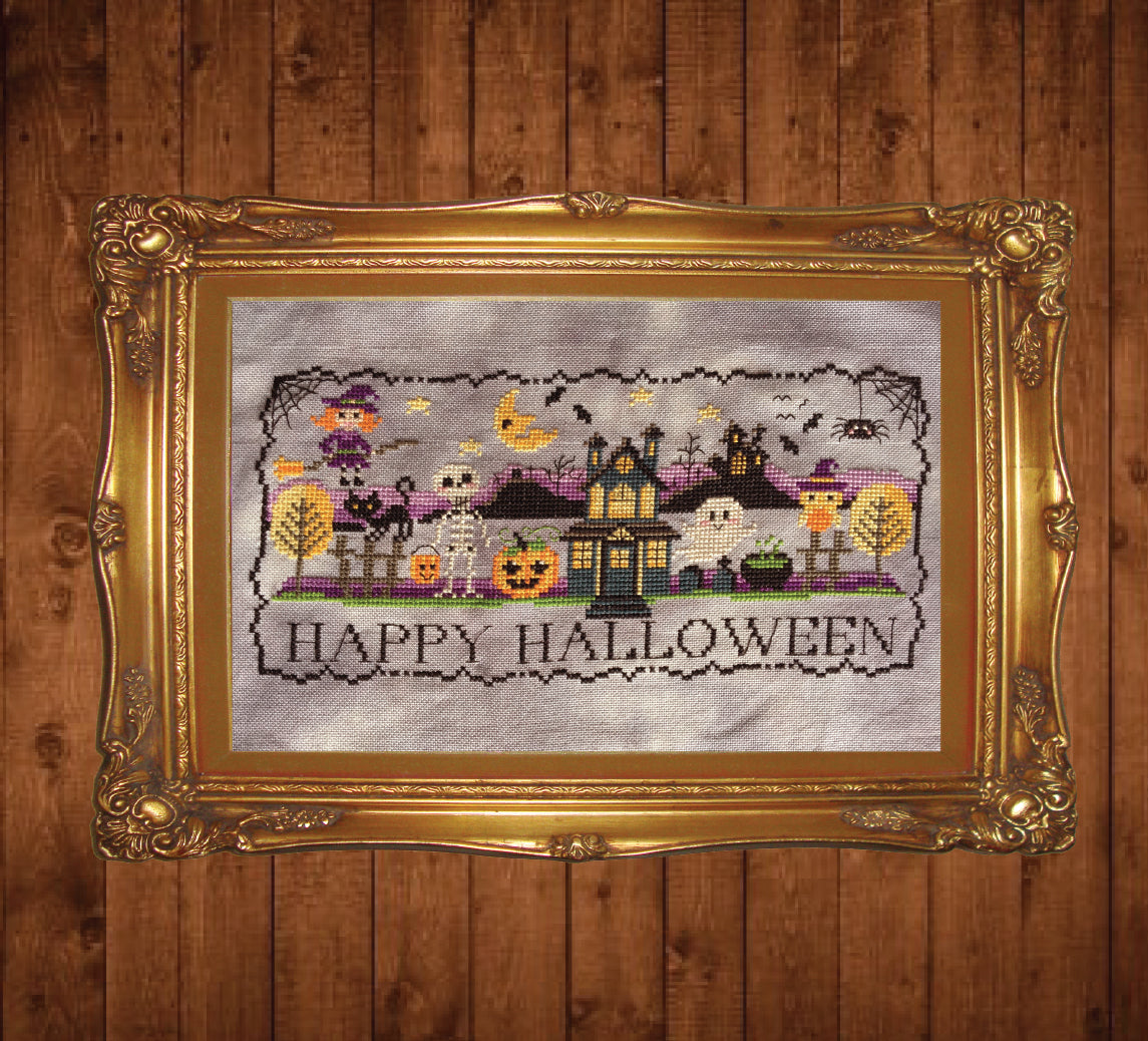 Cross Stitch Pattern - image of Happy Halloween village with skeleton, ghost, haunted house and black border in gold frame on a dark wood grain background.