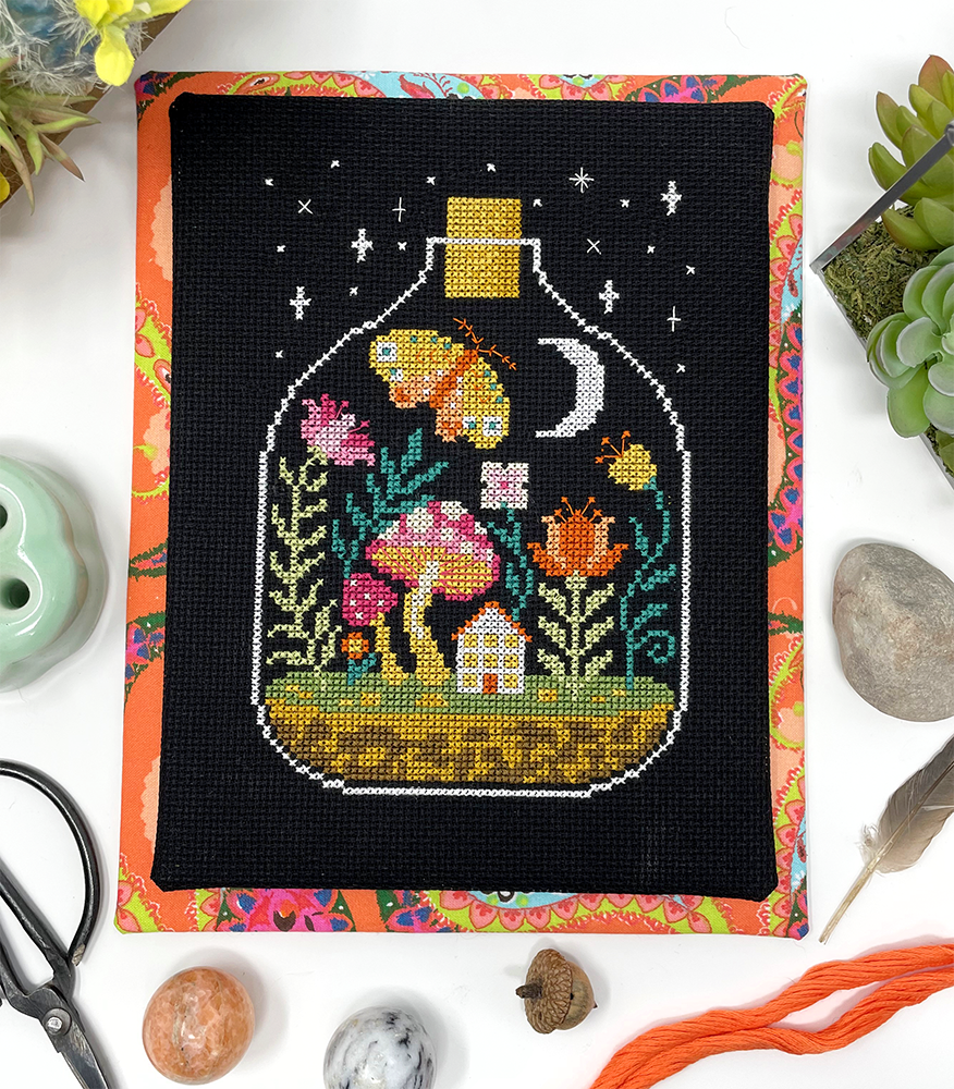 Night house with plants, moth and moon in glass bottle