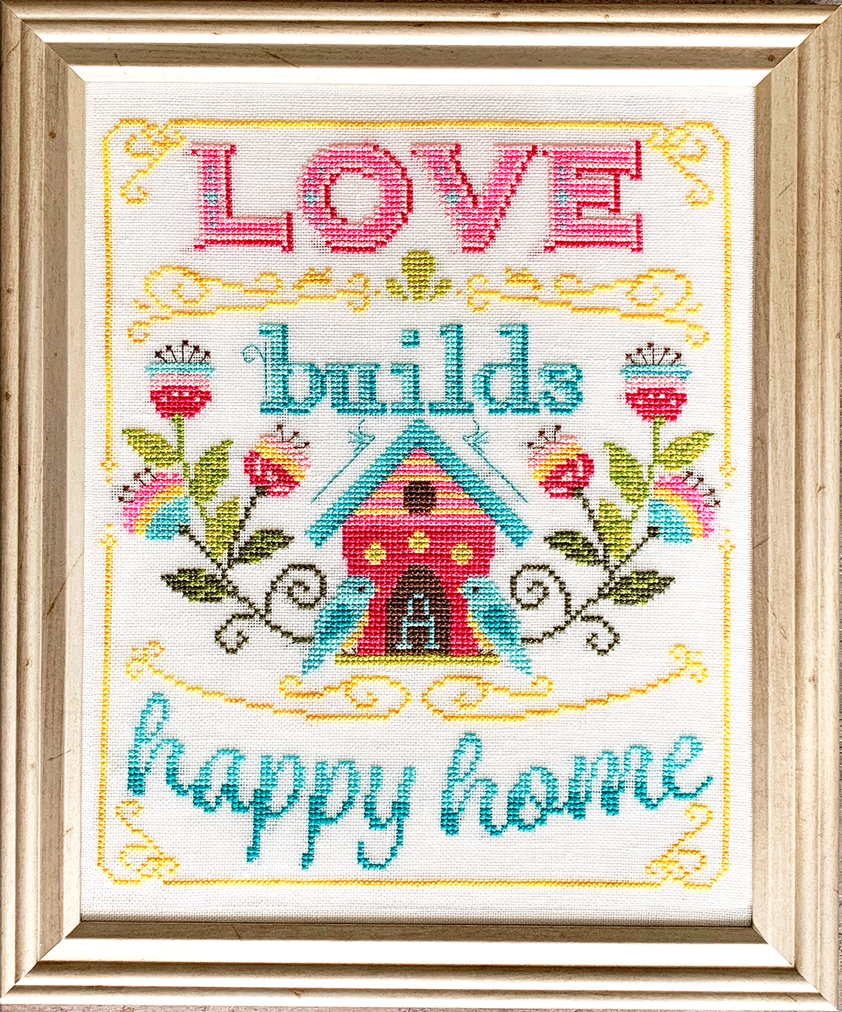 House with flowers and birds with words love builds a happy home