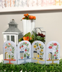 Four glass jars with houses and flowers