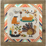 Cross-stitched design with a turkey, pie, and autumn elements on a wooden frame.