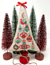 Festive ornaments with bird on top of tree