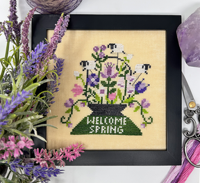 Sheep in flowers with the words welcome spring
