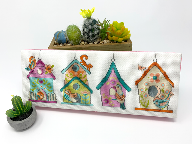 Four bird houses with birds and flowers