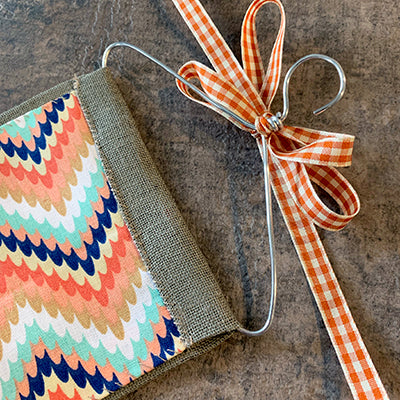 Bow tied around hanger of piece