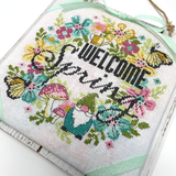 flowers gnome and butterflies with the words welcome spring