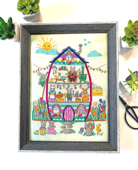 Easter house with bunny family and fence