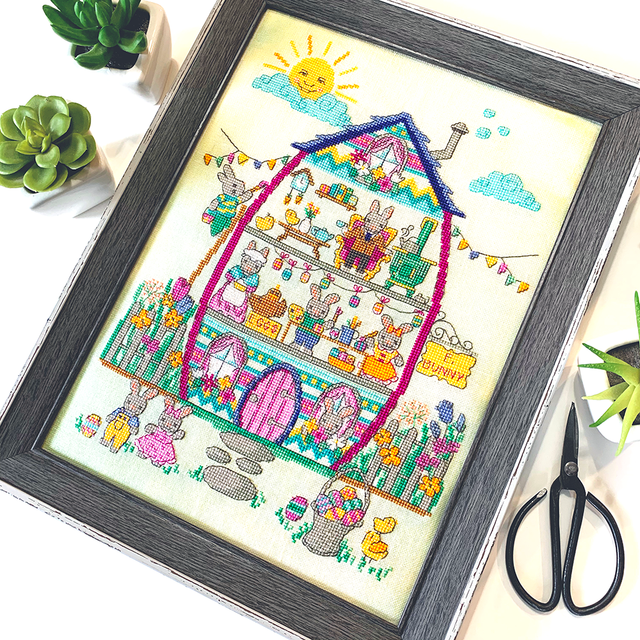 Easter house with bunny family and fence